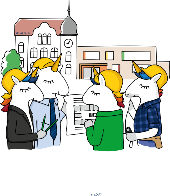 Vier LaDaDi-Einhörner stecken ihre Köpfe über einen Bauplan.